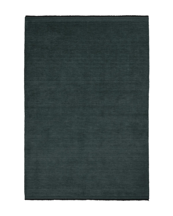 Silvio Dusk rug in deep muted blue with micro fringe border detail, sustainable hand-woven design by Weave Home