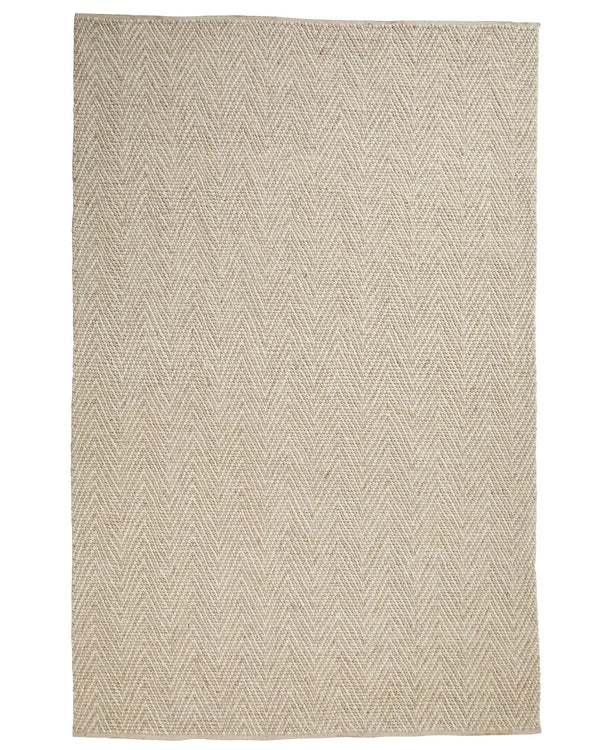 Zambesi Sandstorm wool blend rug in natural beige with tightly woven chevron pattern and cotton braided edge by Weave Home