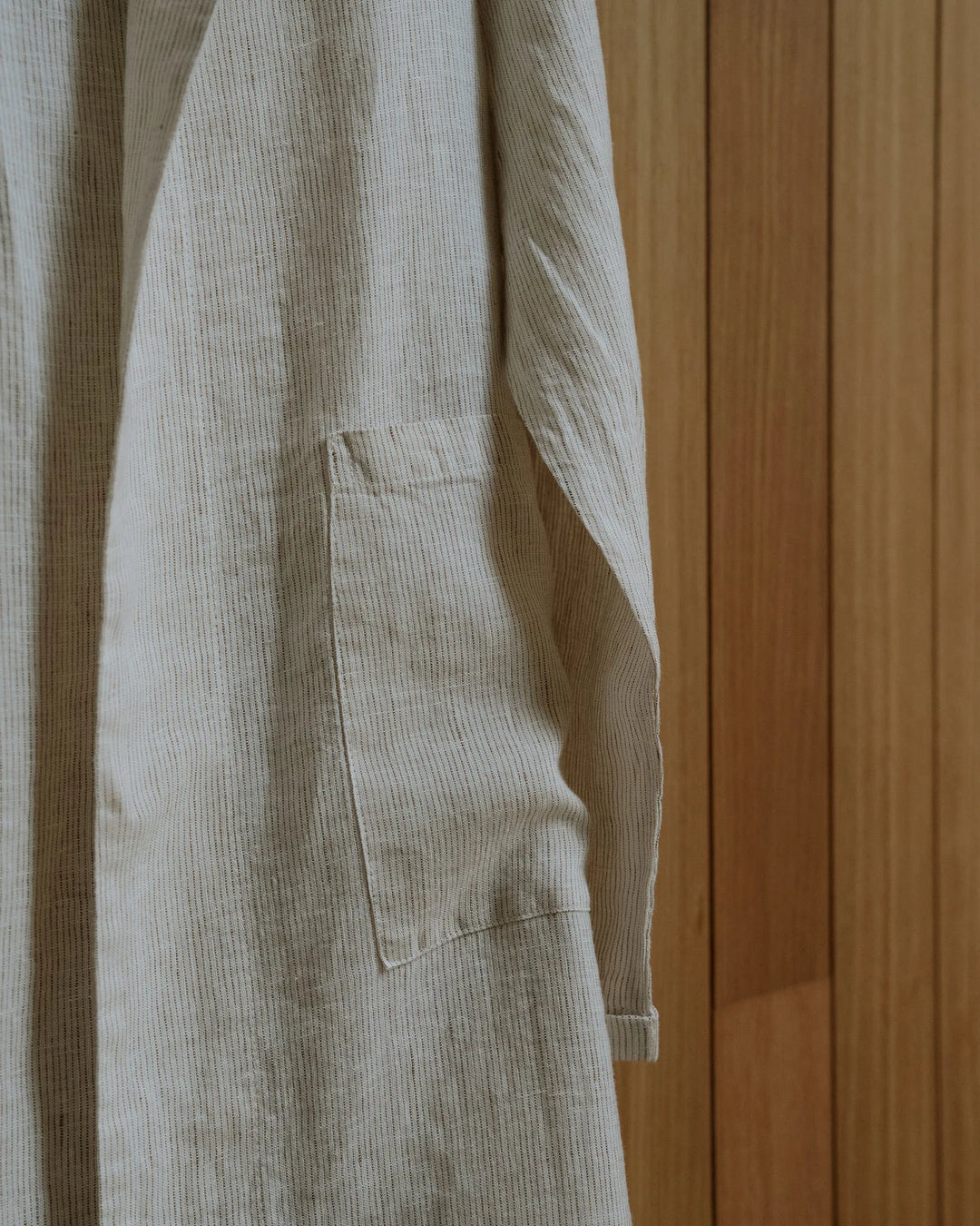 Sova Robe Savanna detail view, cream linen with subtle pinstripe and patch pocket, by Weave Home