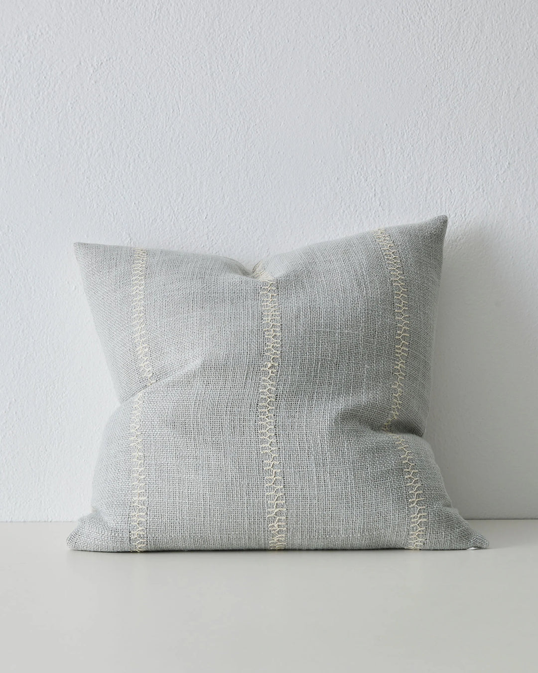 Maddalena Glacier 50x50 cushion in light blue with cream embroidery stitching detail down centre by Weave Home
