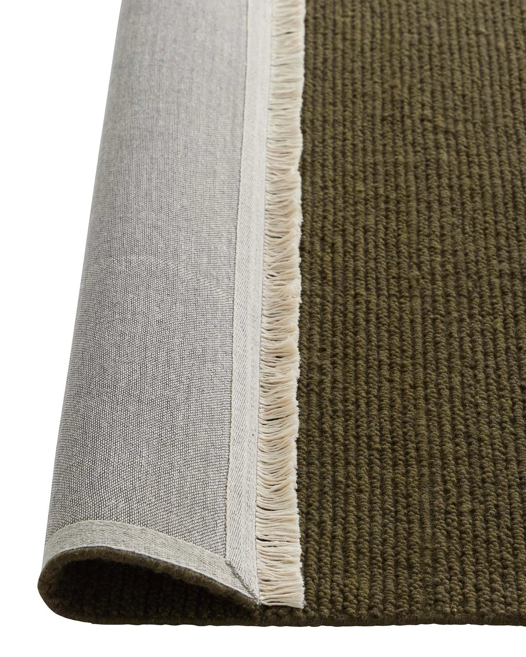 Fabien Moss rug detail showing ribbed wool weave texture with cream fringe edge by Weave Home
