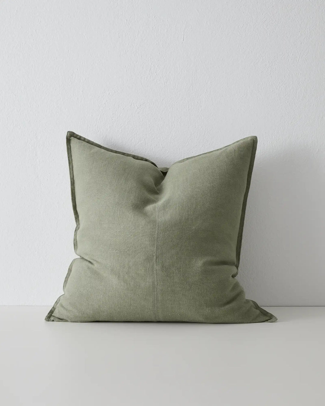 Como Olive 60x60 linen cushion in soft sage-green, stonewashed European linen with piped seams, front view by Weave Home
