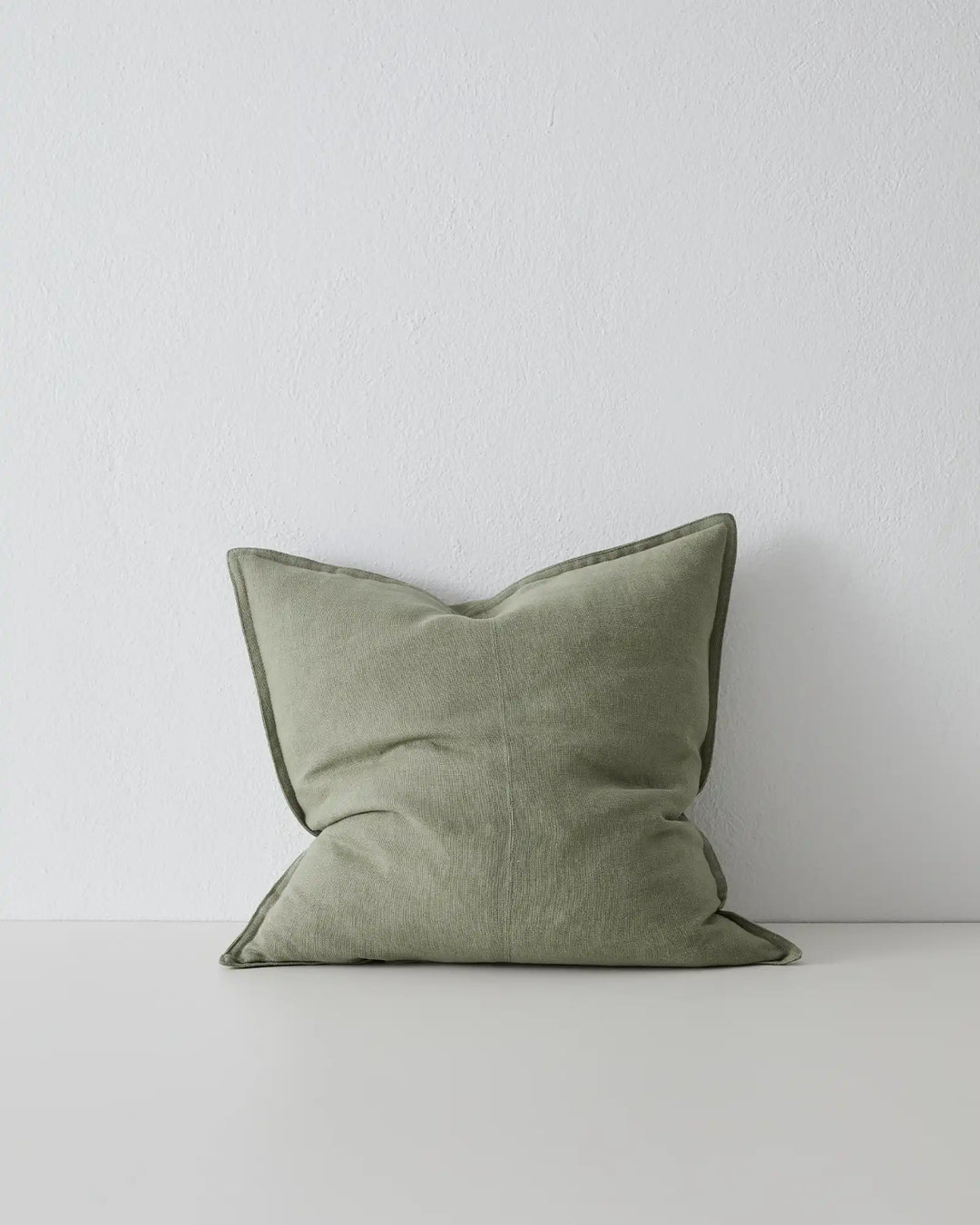 Como Olive linen cushion 50x50cm in soft sage green with contrast piping, by Weave Home