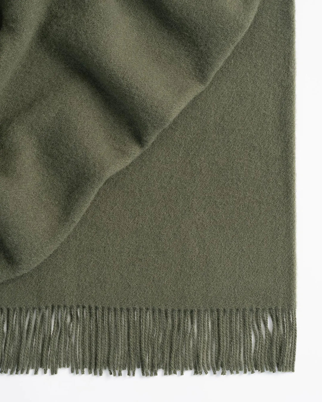 Nevis Juniper lambswool throw in soft green, 130x200cm, with tassel border detail by Weave Home