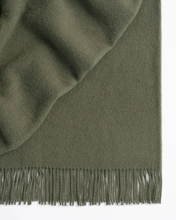 Nevis Juniper lambswool throw in soft green, 130x200cm, with tassel border detail by Weave Home