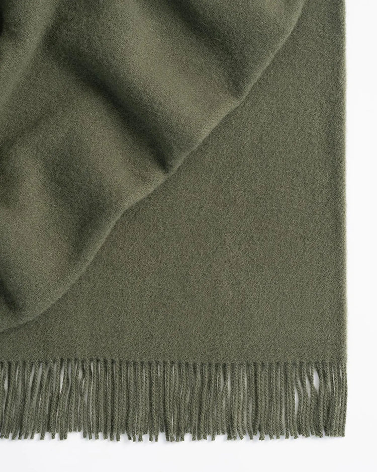 Nevis Juniper lambswool throw in soft green, 130x200cm, with tassel border detail by Weave Home