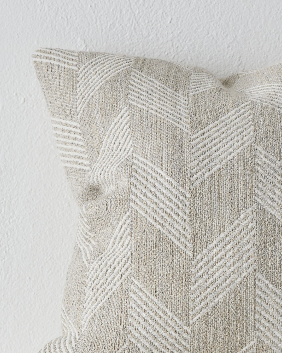 Riva Natural 50x50 linen cushion close-up, showing chevron weave texture and knife edge detail by Weave Home