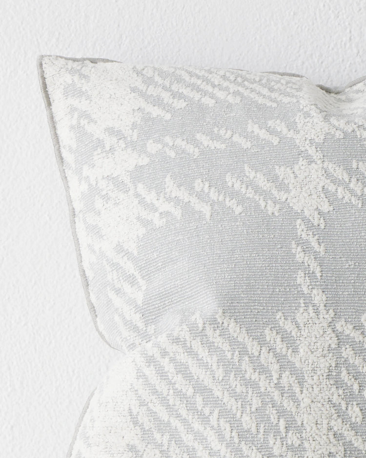 Sienne Mist cushion close-up, oversized check pattern in soft white on pale grey polyester cotton blend, overlocked edge detail, by Weave Home