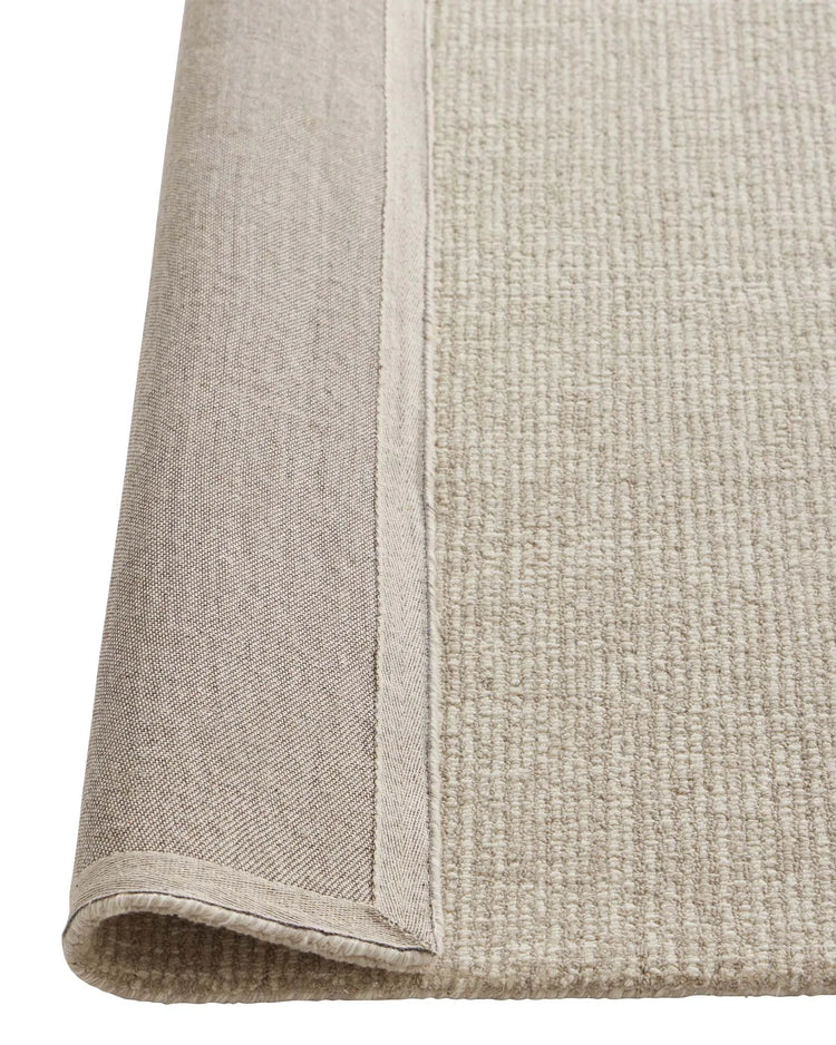 Kaia Moonbeam rug detail view showing contrast loop pile texture and bound edge seam, 100% NZ wool by Weave Home