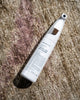 Warwick Unmarkable Textile & Rug Spot Cleaner 300ml spray bottle on natural linen with mauve stripe, by Weave Home