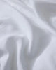 Close-up of crisp white linen bedding with soft folds and natural texture, highlighting the breathable European linen weave and minimalist aesthetic of Ravello sheets