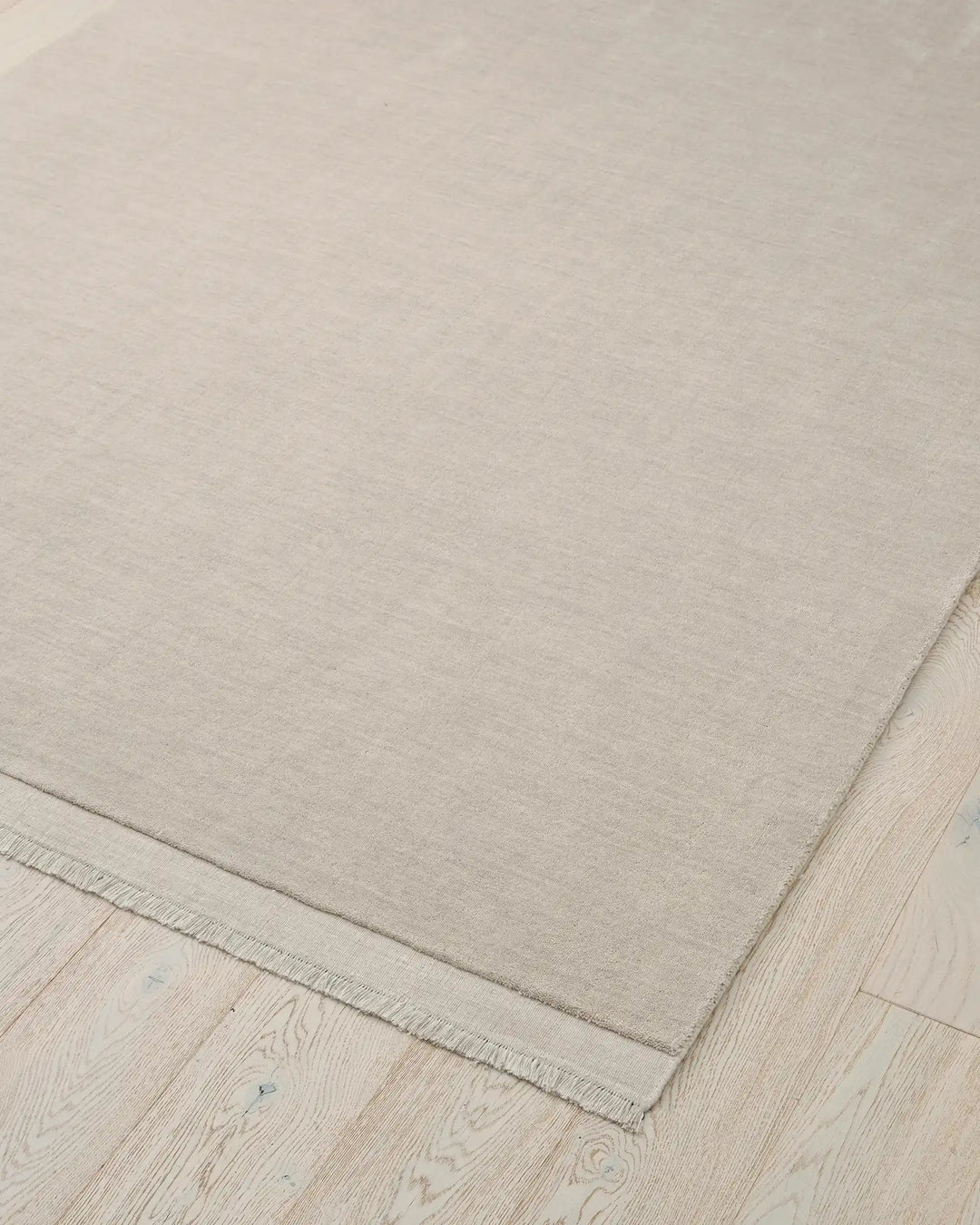 Silvio Ecru hand-woven rug with micro fringe border detail, sustainable wool construction by Weave Home