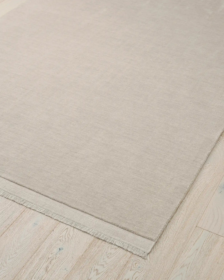 Silvio Ecru hand-woven rug with micro fringe border detail, sustainable wool construction by Weave Home