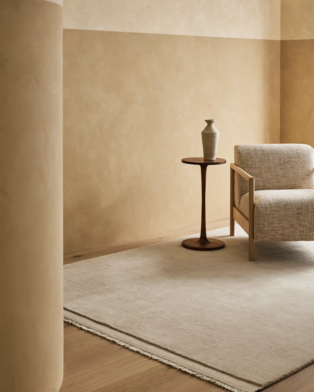 Silvio Ecru hand-woven rug with micro fringe border detail in sustainable styling, displayed in neutral living room setting by Weave Home