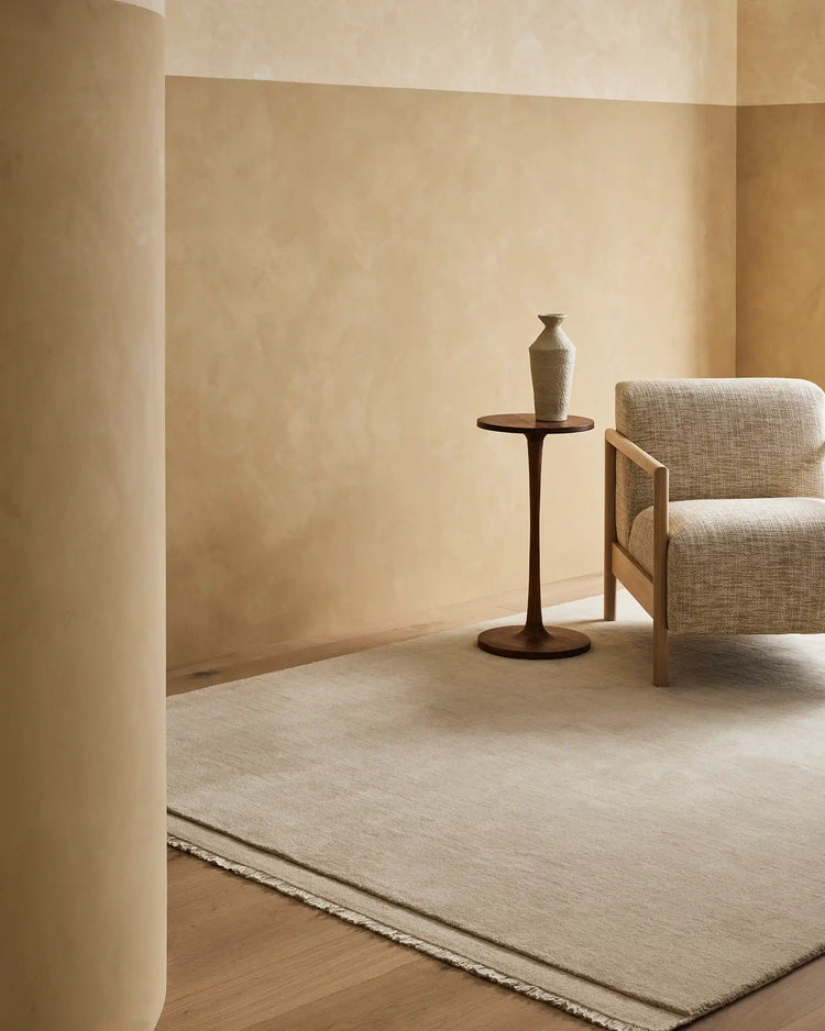 Silvio Ecru hand-woven rug with micro fringe border detail in sustainable styling, displayed in neutral living room setting by Weave Home
