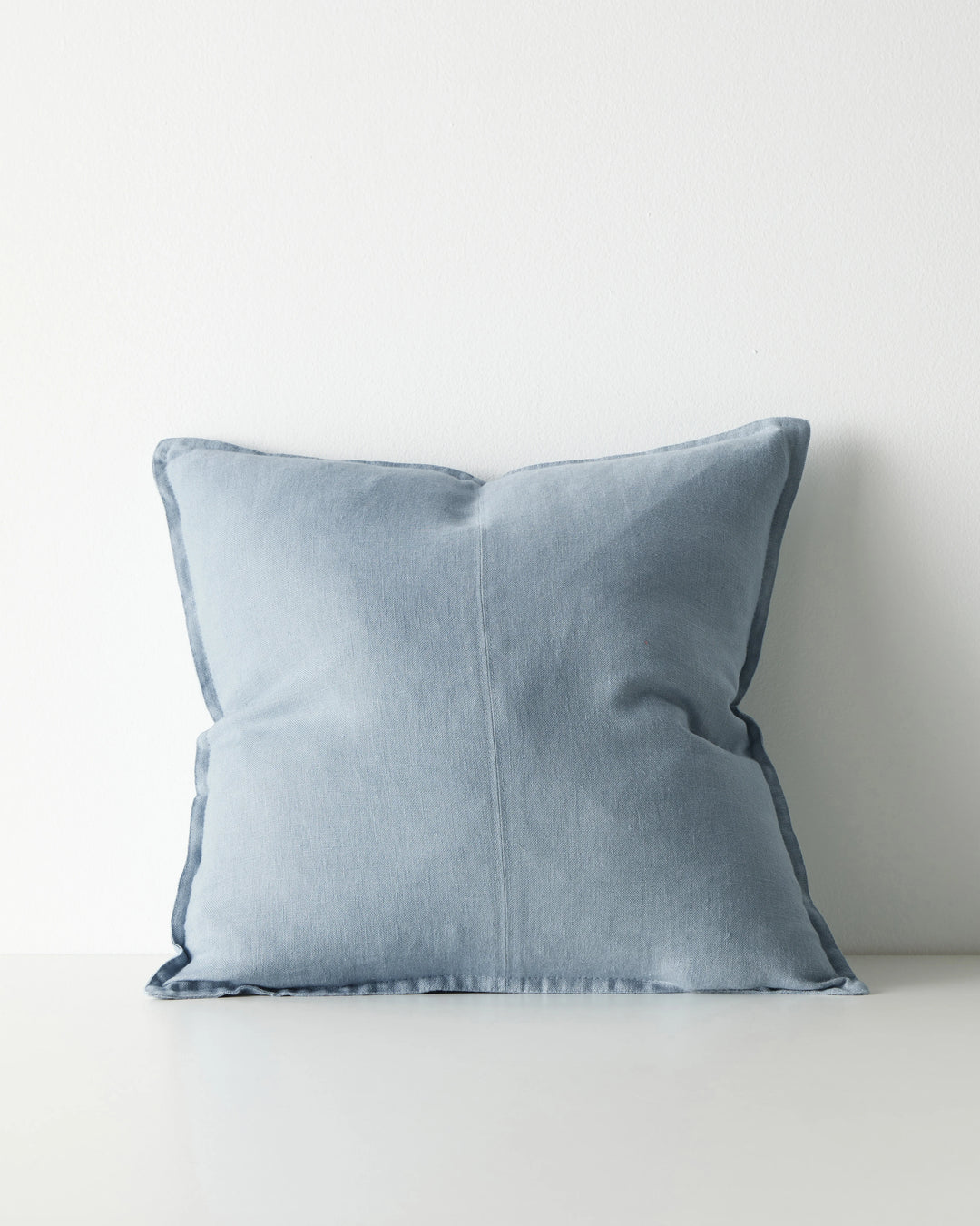 Como Horizon 50x50 cushion in light blue linen with piped edges, front view by Weave Home