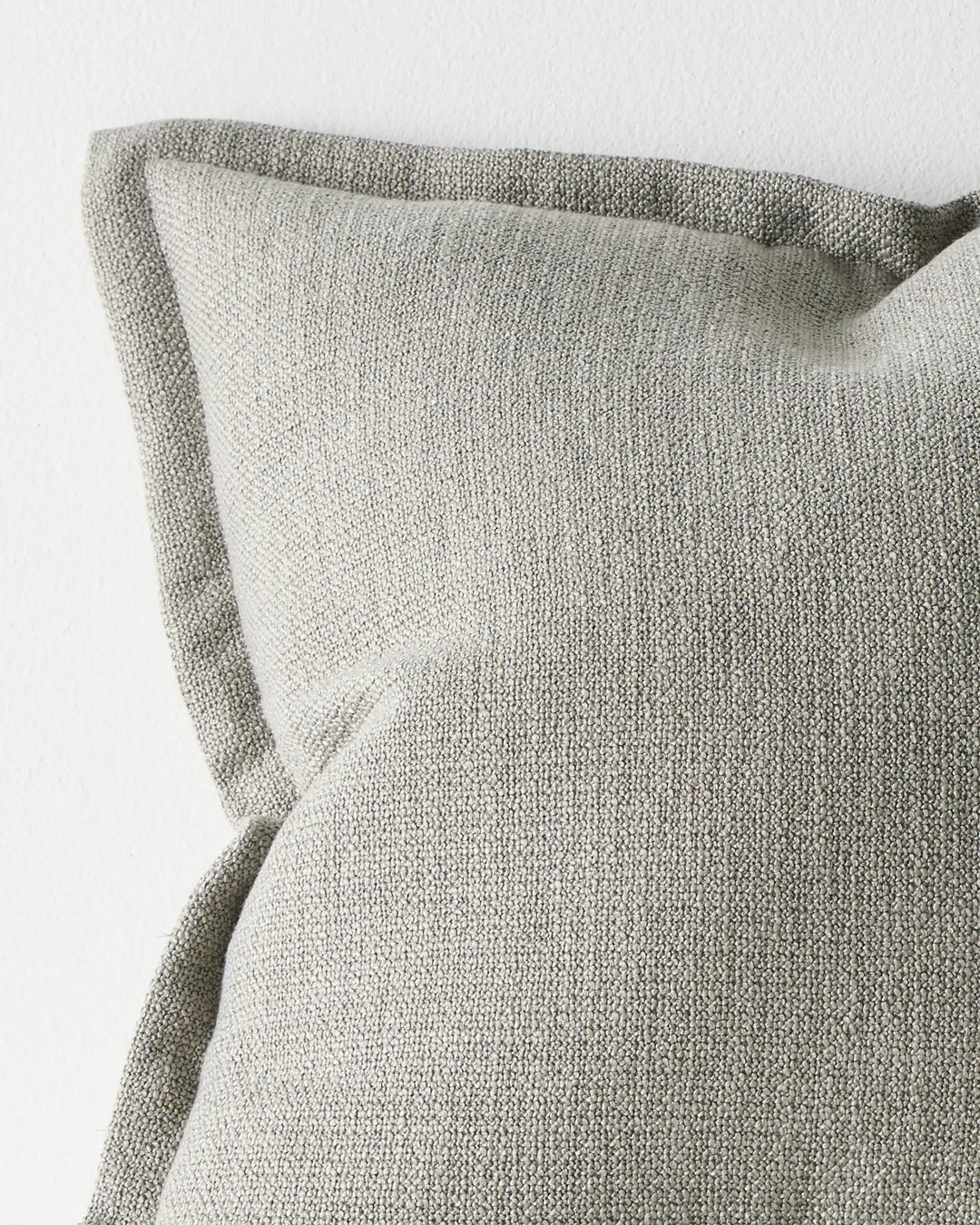 Figlio Fog 50x50 cushion cover detail, showing chunky woven polyester texture with piped edge seams by Weave Home