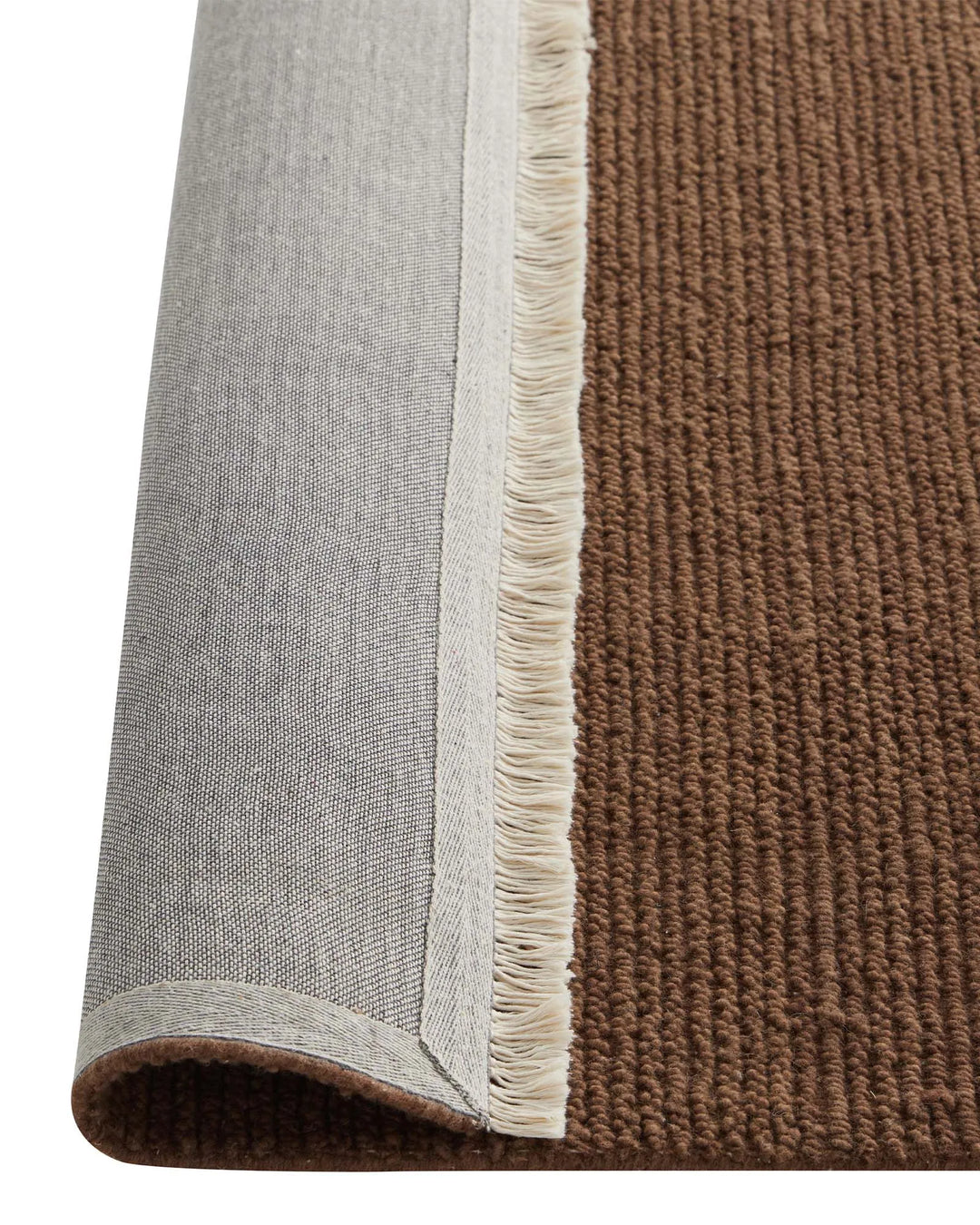 Fabien Bark textured wool rug detail, showing ribbed weave construction and cream fringe edge by Weave Home