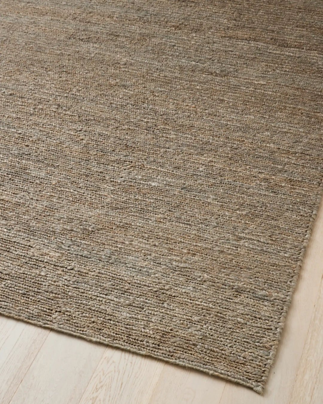 Suffolk Mineral jute rug in cool-toned brown with sage undertone, hand-woven plain weave detail, by Weave Home