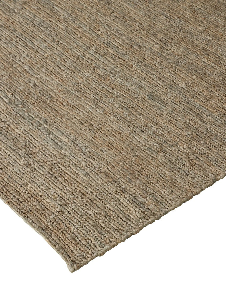 Suffolk Mineral jute rug, close-up weave detail showing textured hand-woven construction in cool-toned brown with sage undertone by Weave Home
