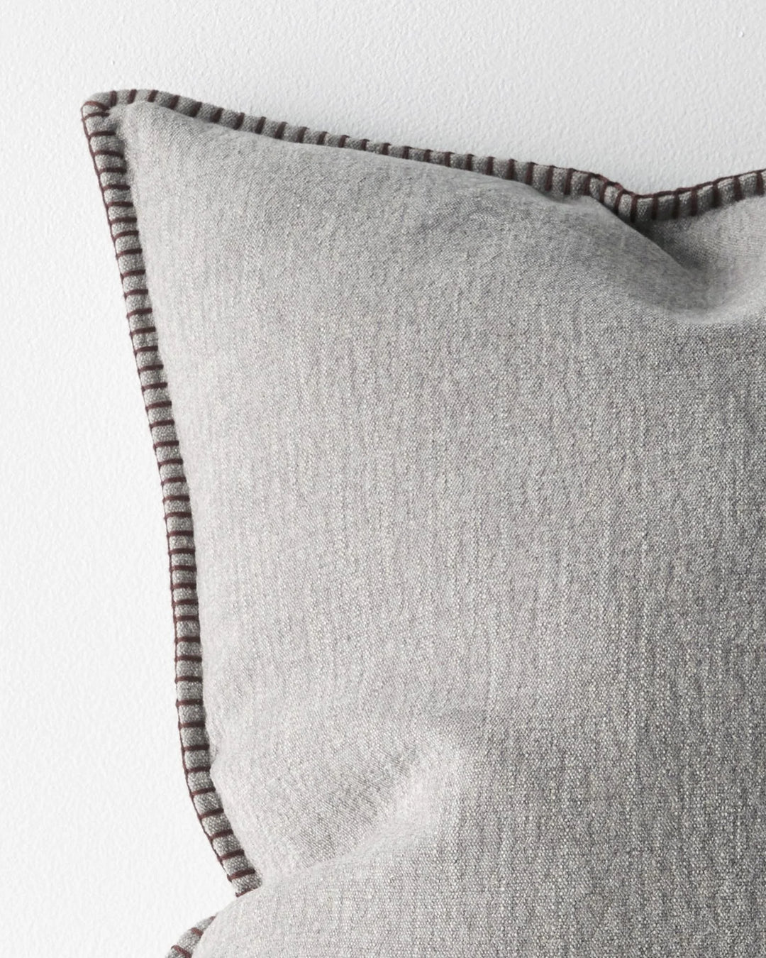 Alba Dove cushion detail, showing blanket stitch edge in contrasting burgundy thread on linen-polyester blend by Weave Home