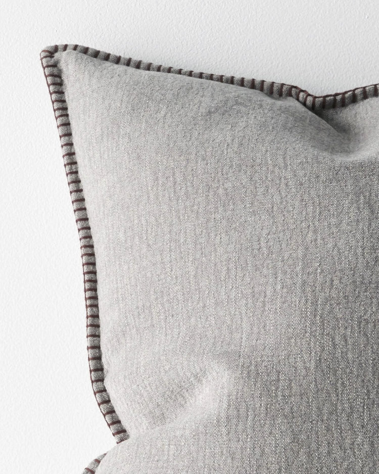 Alba Dove cushion detail, showing blanket stitch edge in contrasting burgundy thread on linen-polyester blend by Weave Home