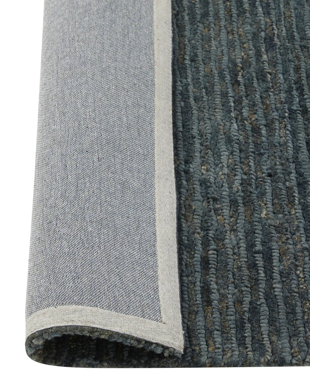 Bastian Dusk textured jute rug detail, showing looped and cut linear weave in charcoal blue with natural cream backing, by Weave Home