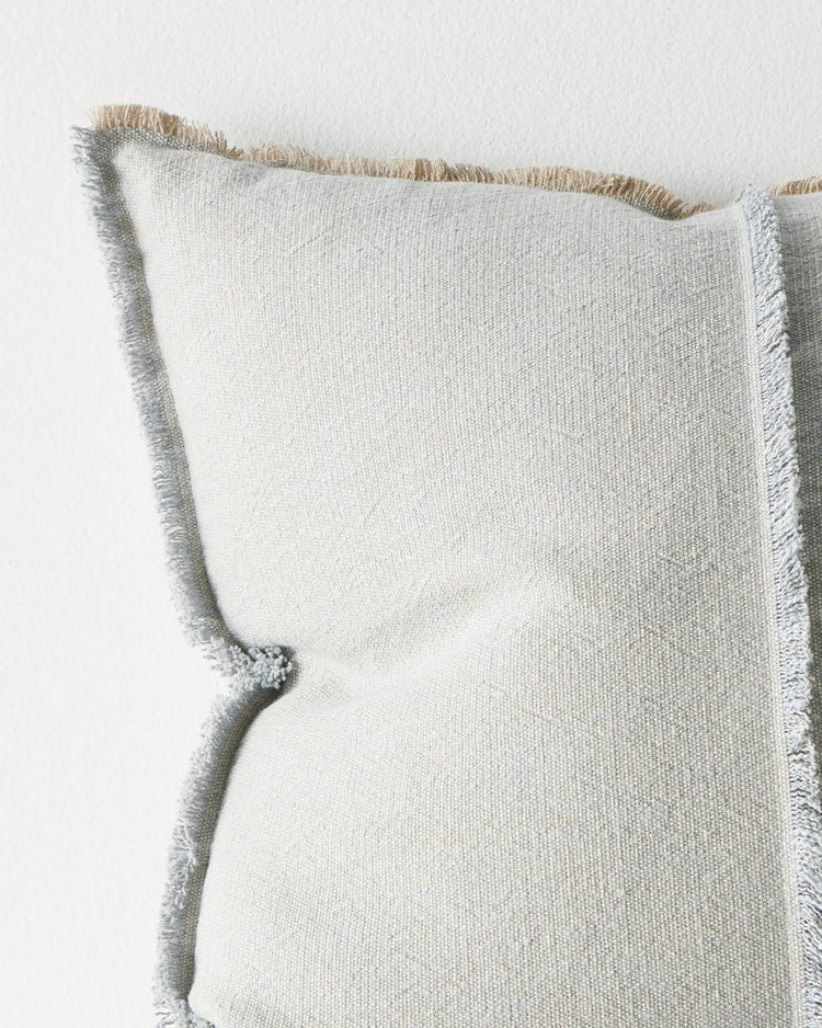 Adela Haze cotton linen cushion close-up, light blue with beige texture and raw-edge fringe by Weave Home