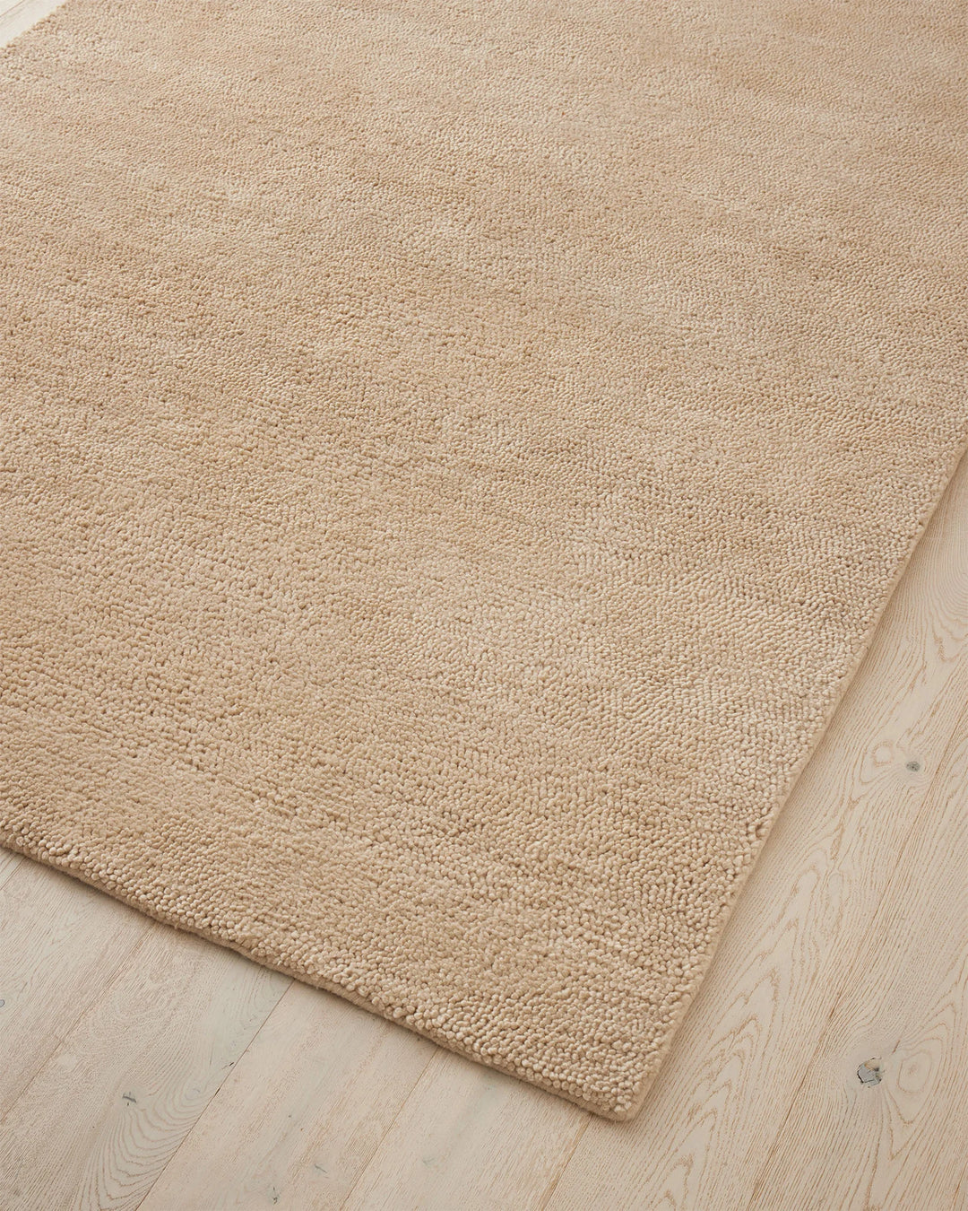 Valencia Dune rug corner detail, soft sandy beige chunky wool weave, high-traffic plush rug by Weave Home