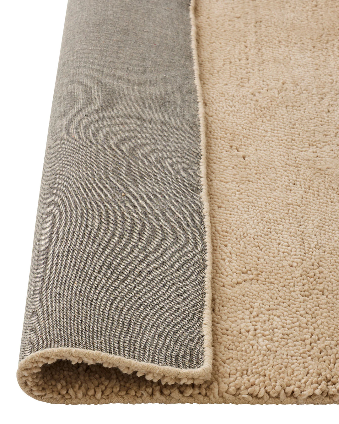 Valencia Dune plush woven rug in soft beige, detail of chunky NZ wool pile and neutral binding edge by Weave Home