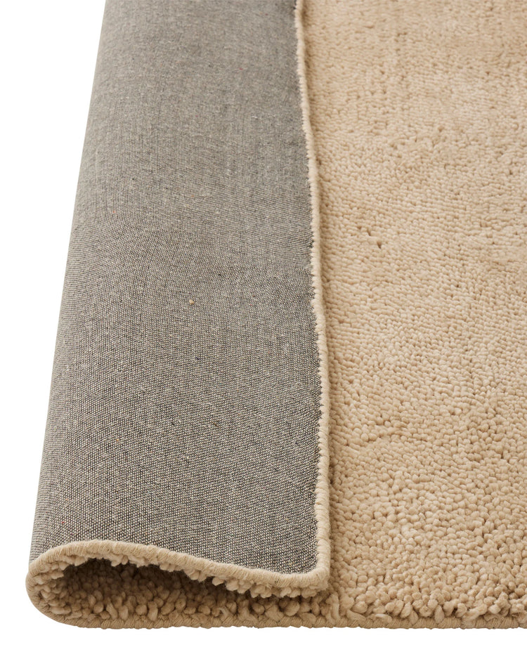 Valencia Dune plush woven rug in soft beige, detail of chunky NZ wool pile and neutral binding edge by Weave Home