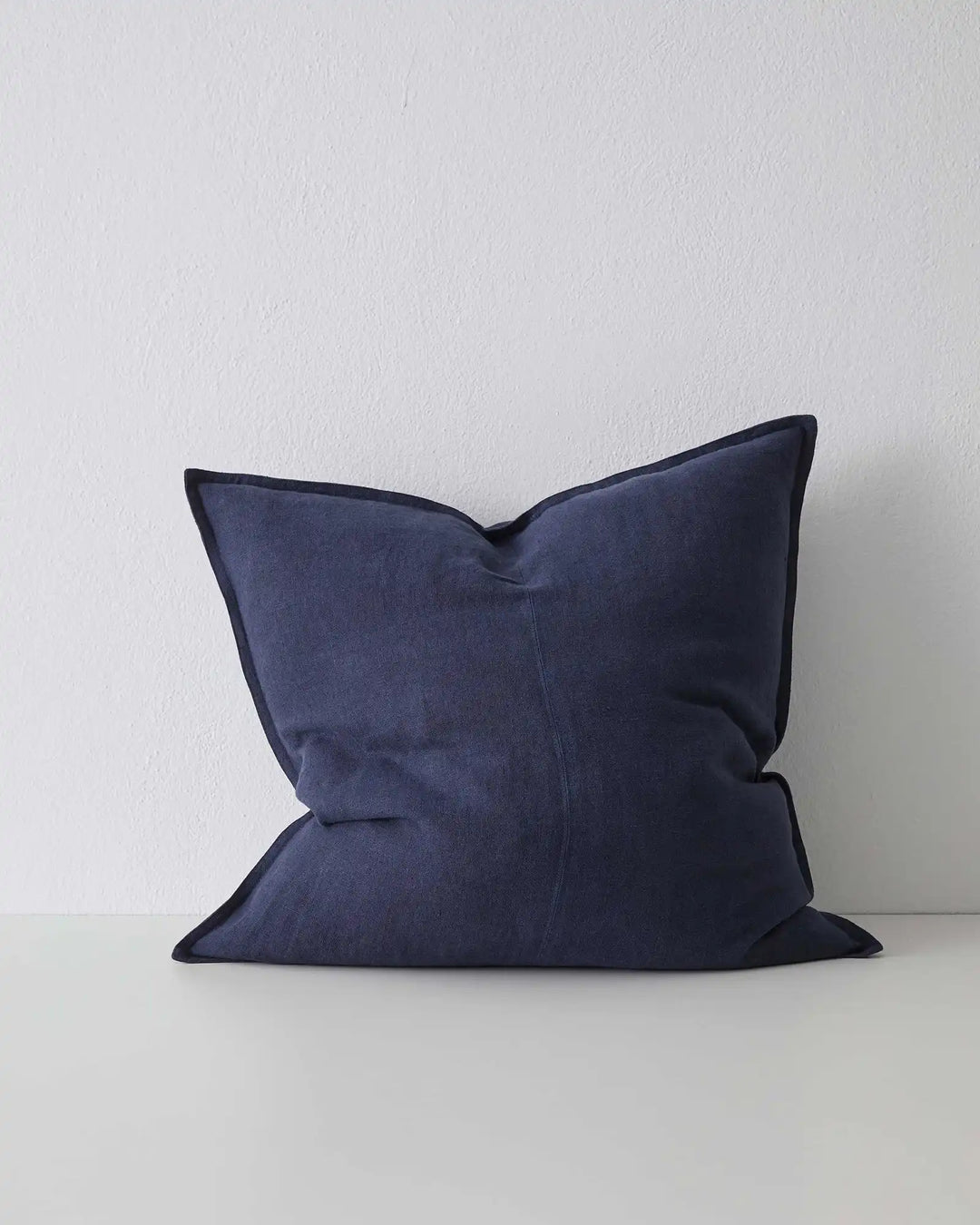Como Ocean linen cushion in deep navy, 60x60cm, with contrast piping detail by Weave Home
