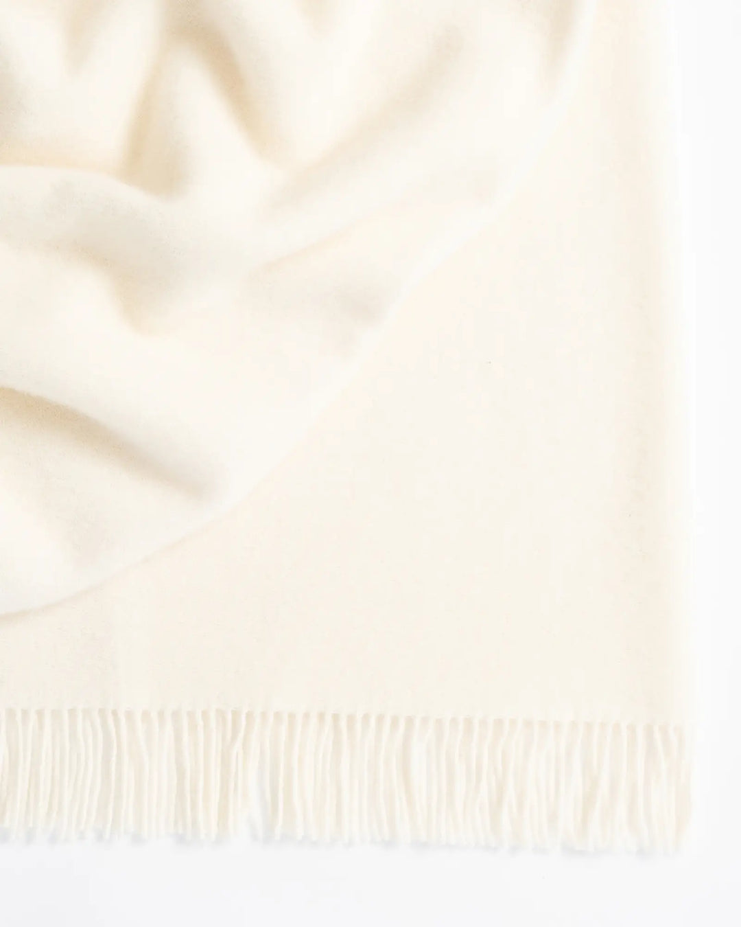 Nevis Snow lambswool throw in pure white with tassel fringe border, 130x200cm, by Weave Home