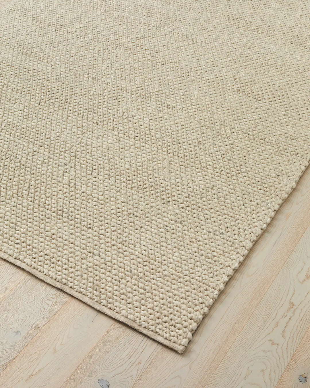 Emerson Seasalt woven rug corner detail, warm off-white NZ wool and viscose with textured weave, by Weave Home