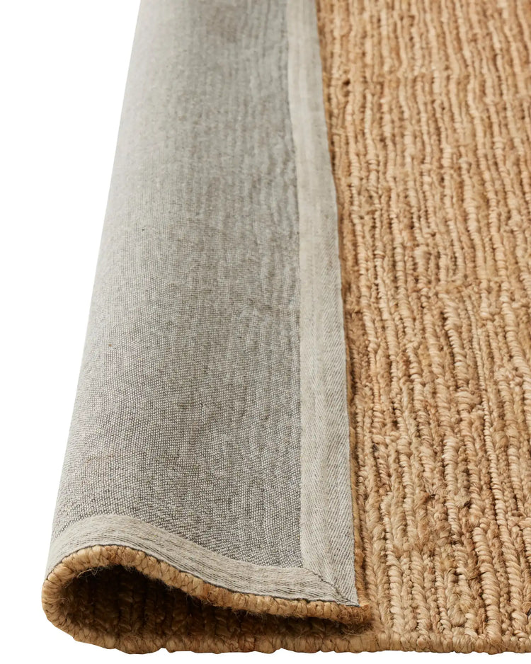 Suffolk Natural jute rug detail showing hand-woven texture and cotton backing edge by Weave Home