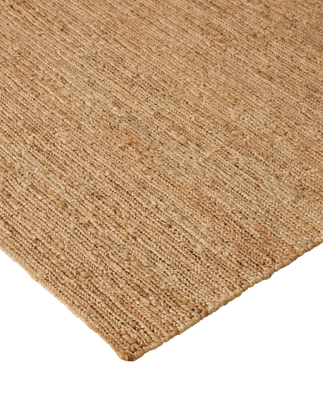 Suffolk Natural jute rug corner detail, hand-woven textured weave in golden brown with cotton edging by Weave Home