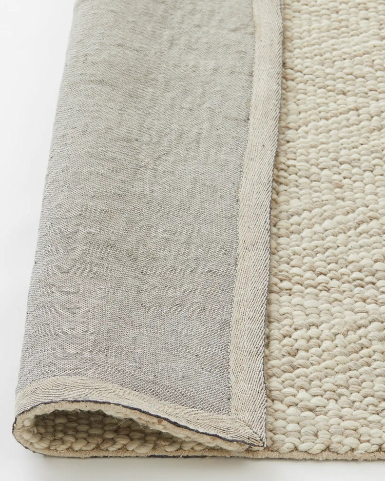 Zambesi Sandstorm wool blend rug detail, showing woven chevron texture and cotton braided edge backing by Weave Home