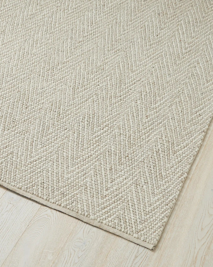 Zambesi Sandstorm wool blend rug detail, showing chevron weave texture and cotton braided edge by Weave Home