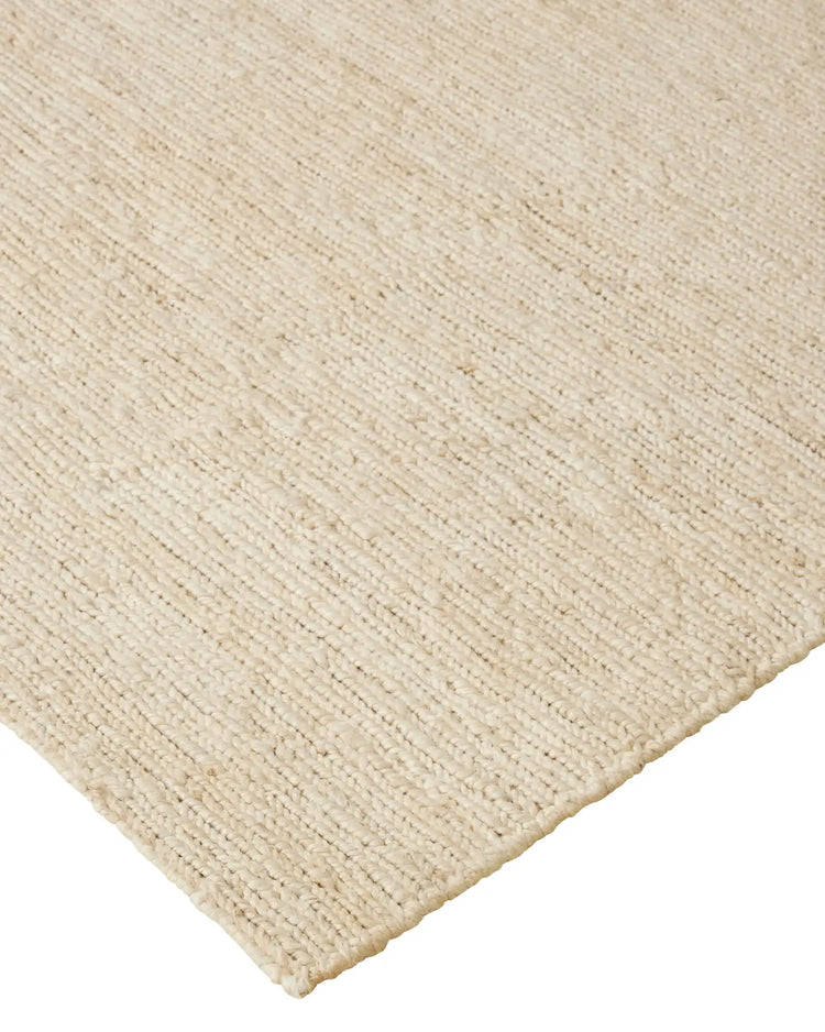 Suffolk Pearl textured jute rug in warm ivory, close-up showing hand-woven weave and cotton edging by Weave Home