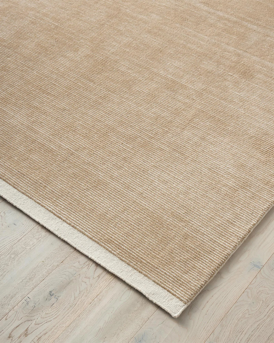 Remo Sand rug, hand-woven NZ wool with cream and taupe stripes, detail view showing textured weave and lowered cut border by Weave Home