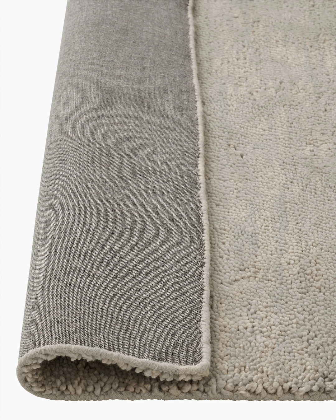 Valencia Cloud rug detail view showing plush woven texture and bound edge in light grey NZ wool by Weave Home