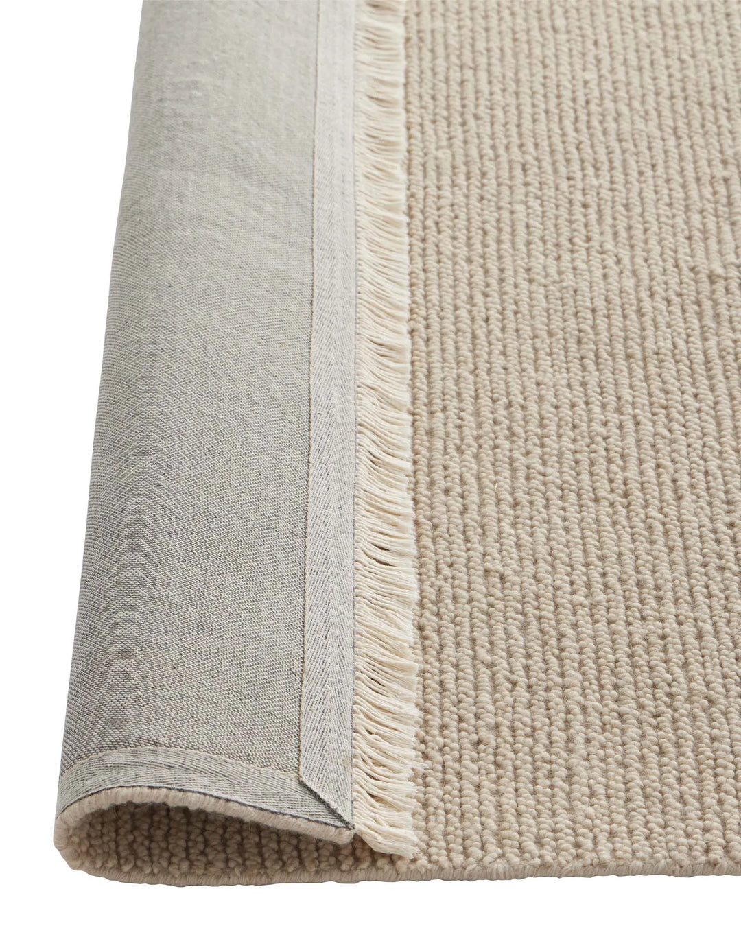 Fabien Stone textured wool rug detail showing chunky loop pile ribbed weave and cream fringe edge by Weave Home