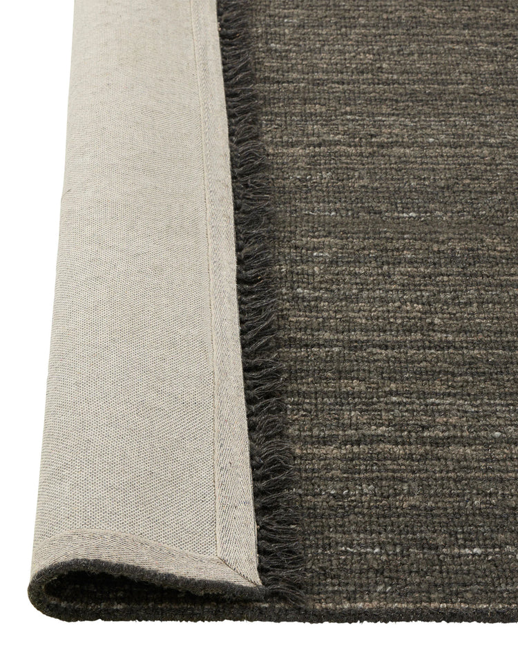 Puglia Pigeon rug detail, charcoal textured weave with fringe edge and natural linen backing by Weave Home