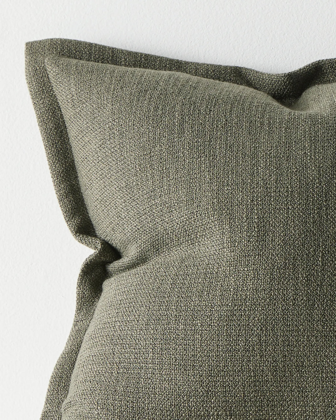 Figlio Kale cushion close-up, showing chunky woven polyester texture in forest green, 50x50cm by Weave Home