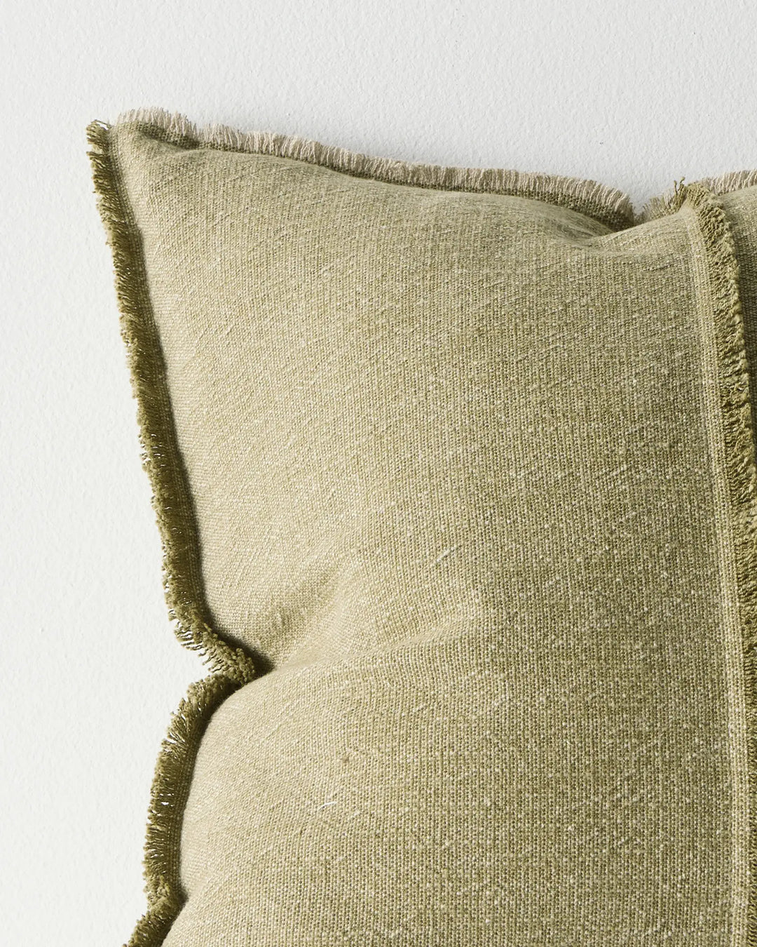 Adela Forest 50x50 cushion in muted olive cotton linen blend, close-up showing raw-edge fringe and textured weave by Weave Home