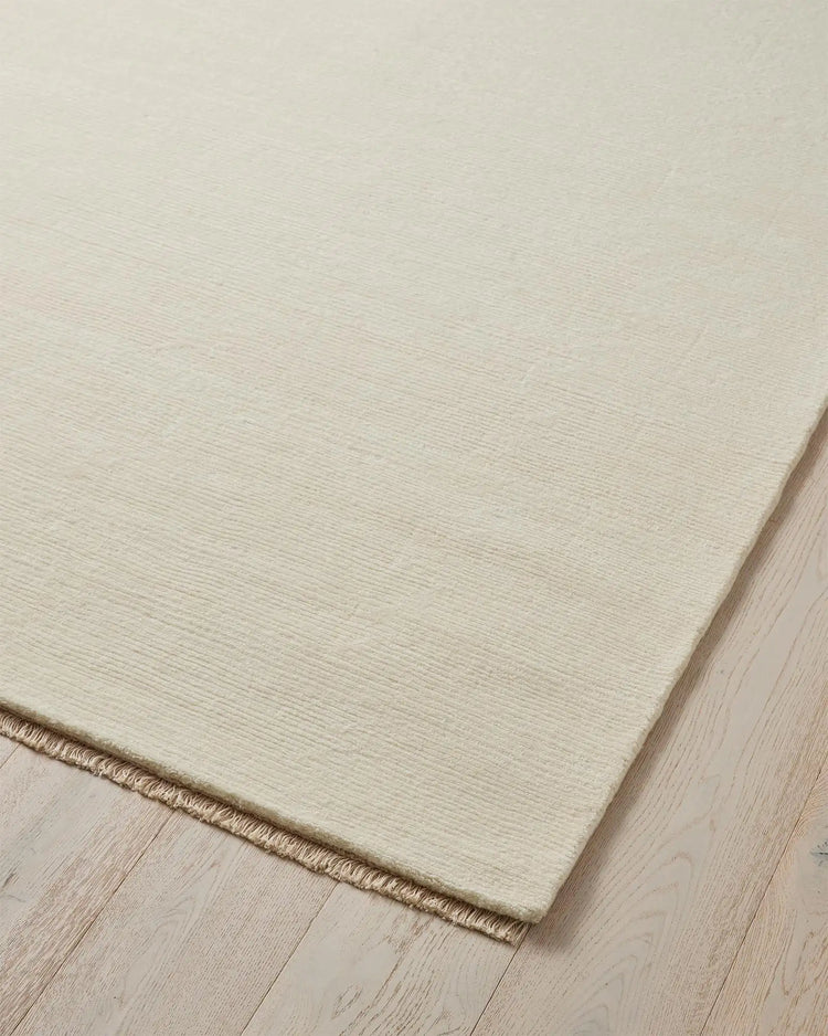 Alessandre Seasalt rug corner detail, hand-woven NZ wool in cool ivory with blanket stitch edge by Weave Home