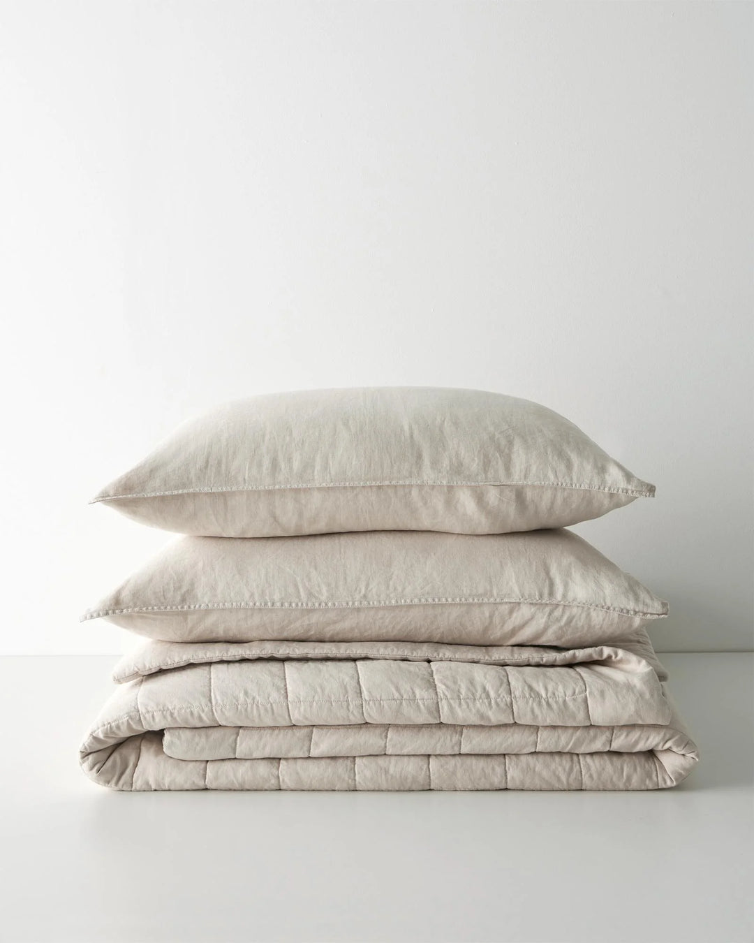 Ravello Coverlet in Bone, European linen with box quilt stitching detail, stacked styling by Weave Home