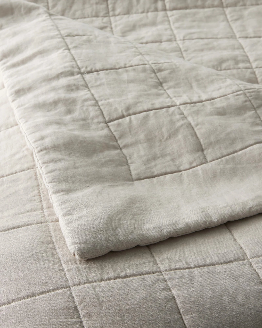 Ravello Coverlet in Bone, detail view of European linen with box quilt stitching and cotton-poly fill by Weave Home
