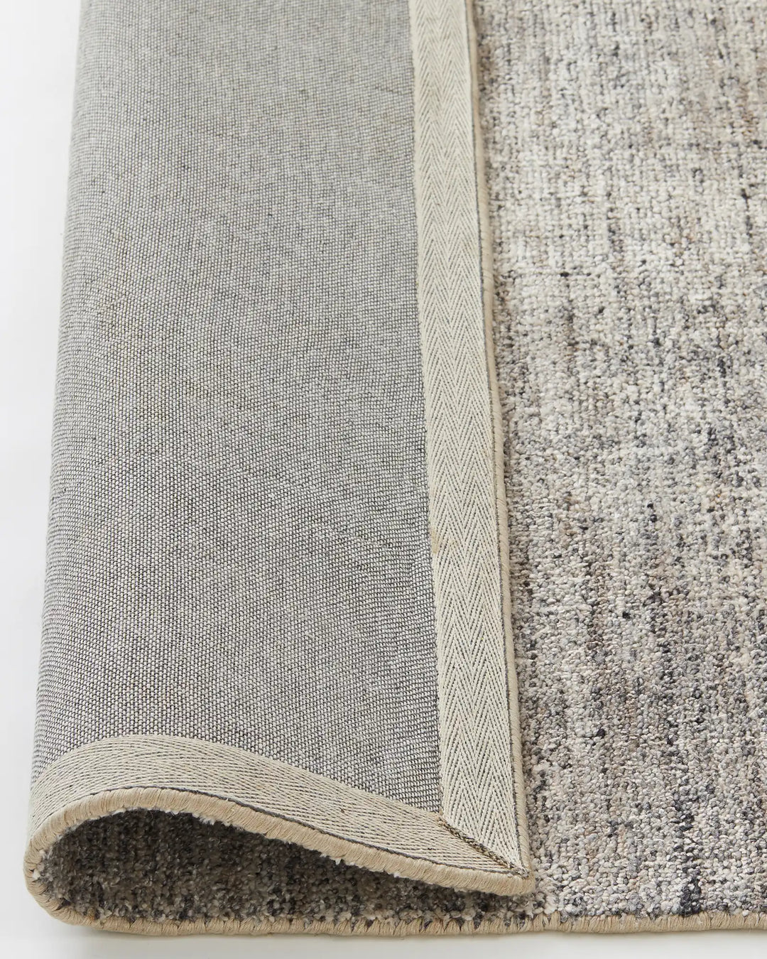 Granito Shale rug backing detail showing wool blend weave with bound edge, by Weave Home