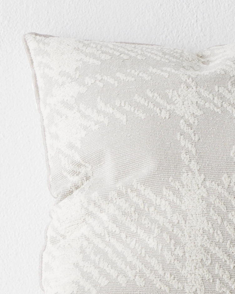 Sienne Moonbeam 50x50 cushion close-up, light grey with white oversized check pattern and overlocked edge detail by Weave Home